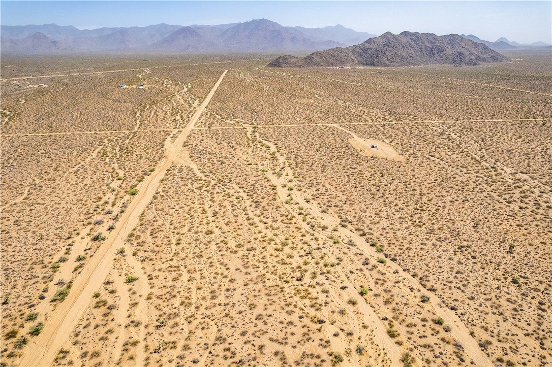 0 East Arroyo Road Yucca, AZ 86438 - Photo 10 of 25 Expansive desert landscape featuring natural terrain and distant mountains, with visible dirt paths crossing the property