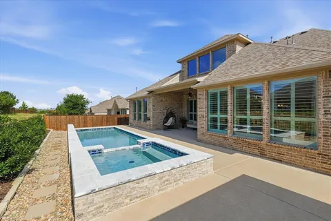 a view of house with swimming pool outdoor seating