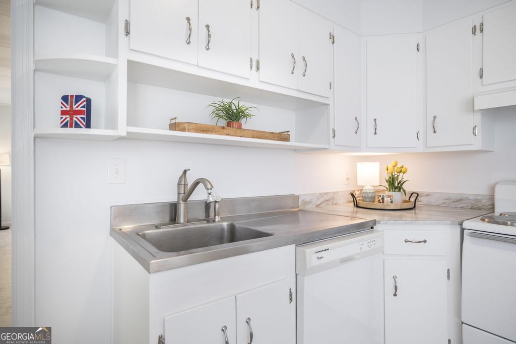 433 Pinecrest Road Macon, GA 31204 - Photo 14 of 38 a kitchen with white cabinets and a sink