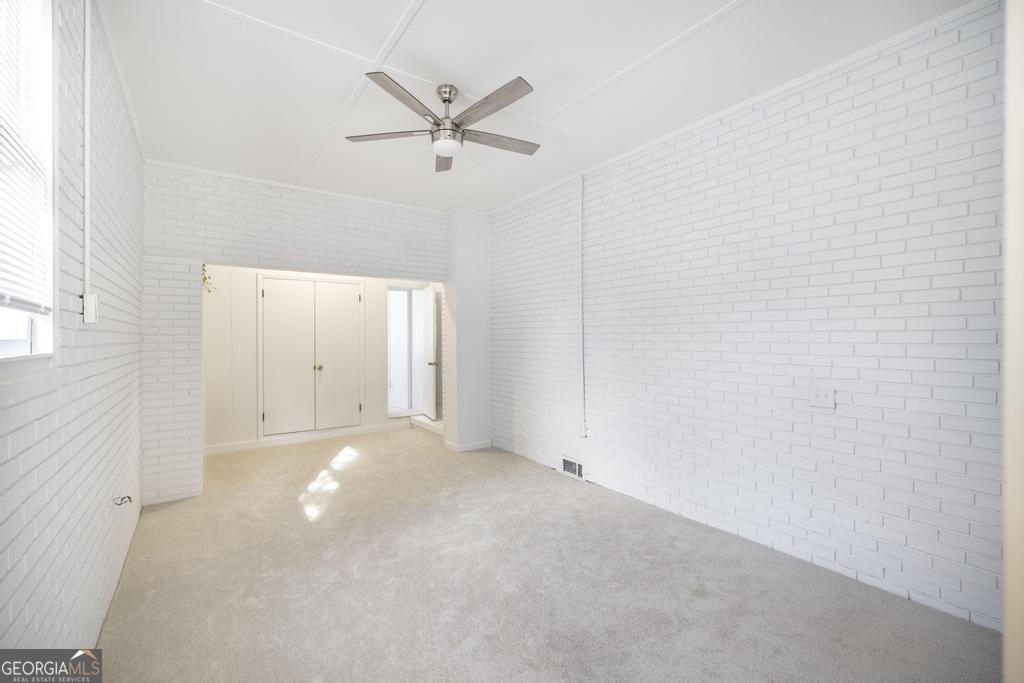 433 Pinecrest Road Macon, GA 31204 - Photo 28 of 38 an empty room with a ceiling fan and a window