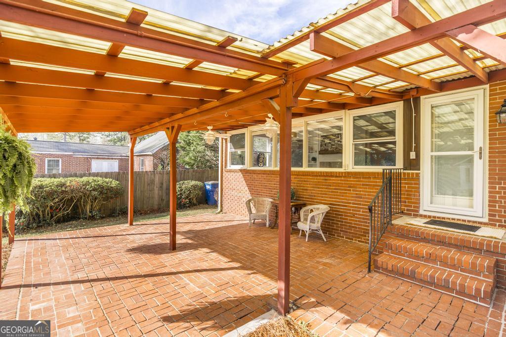 433 Pinecrest Road Macon, GA 31204 - Photo 31 of 38 a patio with a table and chairs and potted plants
