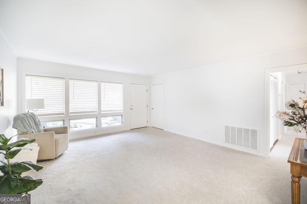 433 Pinecrest Road Macon, GA 31204 - Photo 8 of 38 an empty room with floor to ceiling window and an outdoor view