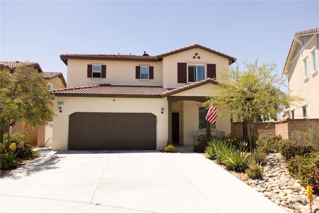 30319 Ramsay Drive Menifee, CA 92584 - Photo 2 of 8 a front view of a house with a yard and garage