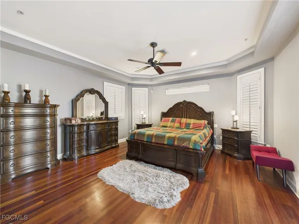 a living room with a couch wooden floor and a view of kitchen