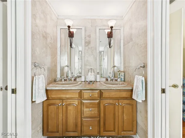 a bathroom with a double vanity sink and mirror