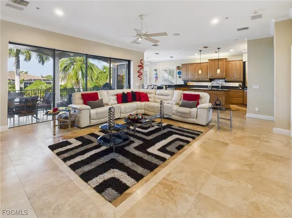 a living room with kitchen appliances and a large window