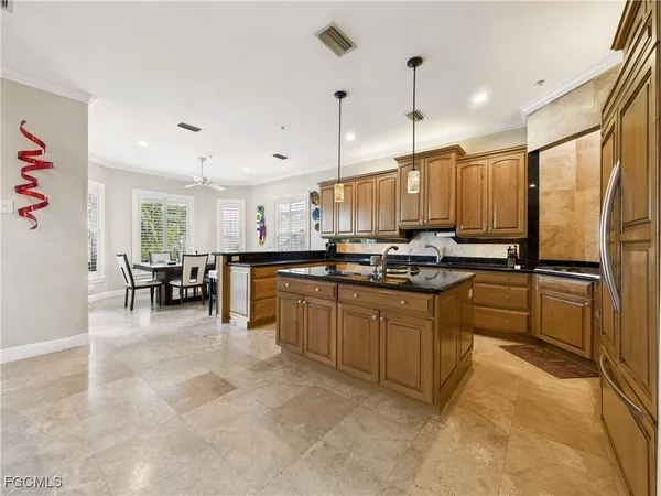 a kitchen with stainless steel appliances granite countertop a refrigerator sink and cabinets