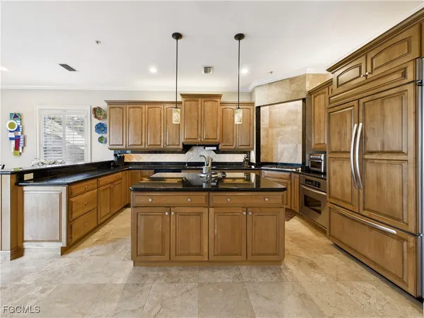 a kitchen with stainless steel appliances granite countertop a refrigerator and a sink