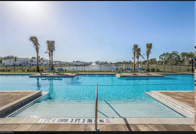 a view of a swimming pool with outdoor seating