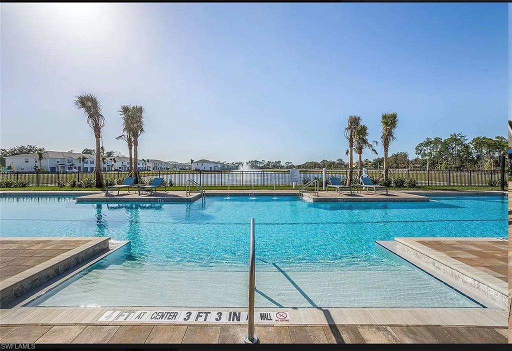 15172 Wildflower Circle Naples, FL 34119 - Photo 13 of 16 a view of a swimming pool with outdoor seating