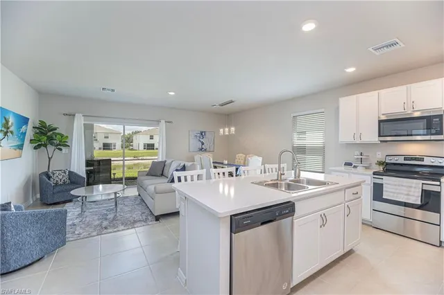 a large white kitchen with a large window
