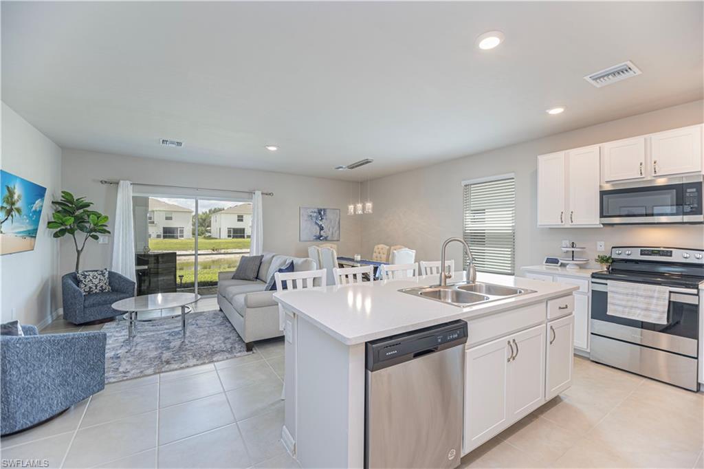 15172 Wildflower Circle Naples, FL 34119 - Photo 4 of 16 a large white kitchen with a large window