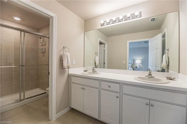 a bathroom with a double vanity sink mirror and double