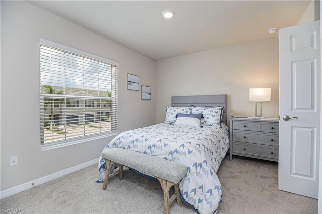 15172 Wildflower Circle Naples, FL 34119 - Photo 7 of 16 a bedroom with a bed and a window