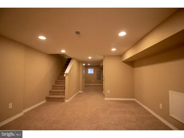 a view of an empty room with stairs