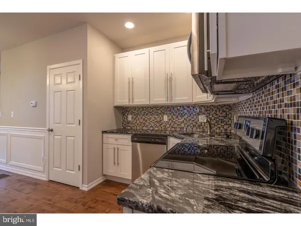 a kitchen with sink and cabinets