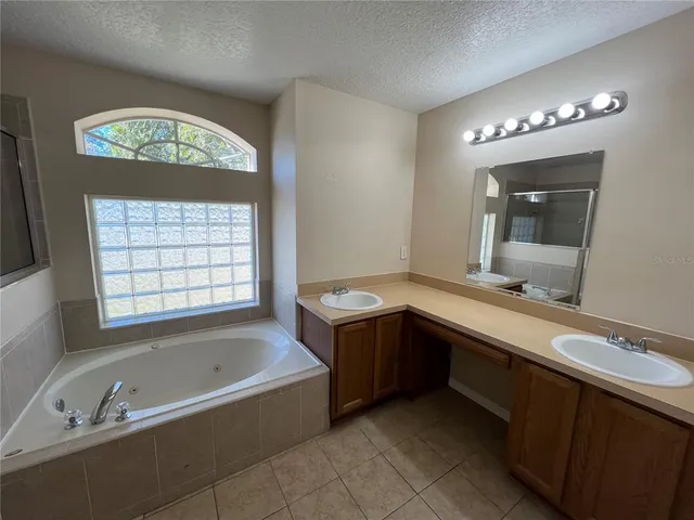 a bathroom with a tub a toilet and a shower