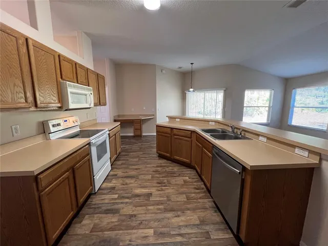 a kitchen with a refrigerator and a sink