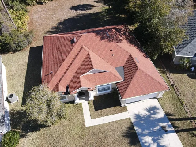 an aerial view of a house with a yard
