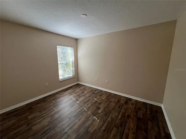 a view of a room that has a bed in it