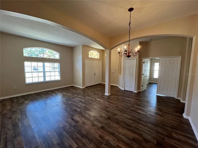 a view of a hallway with chandelier