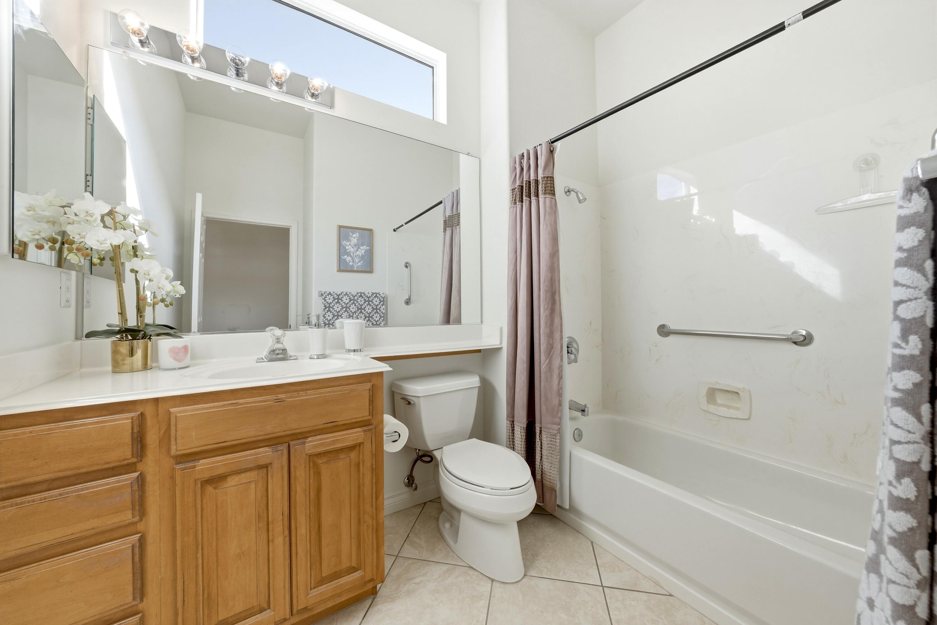 35440 Moorbrook Road Palm Desert, CA 92211 - Photo 25 of 32 a bathroom with a granite countertop sink a toilet mirror and shower