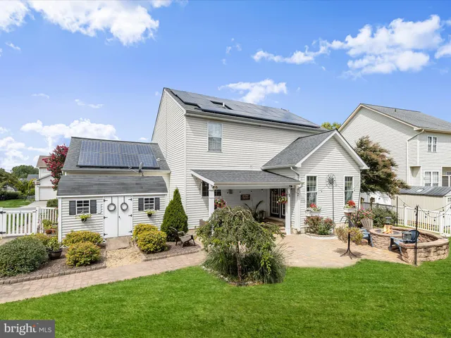 a front view of a house with a yard table and chairs