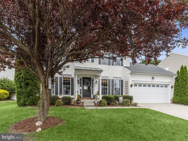 a front view of a house with swimming pool and porch with furniture