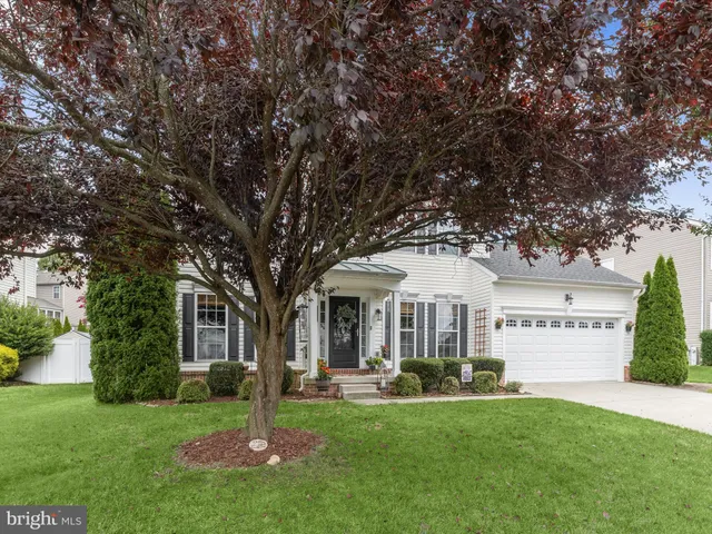 a front view of a house with swimming pool and garden