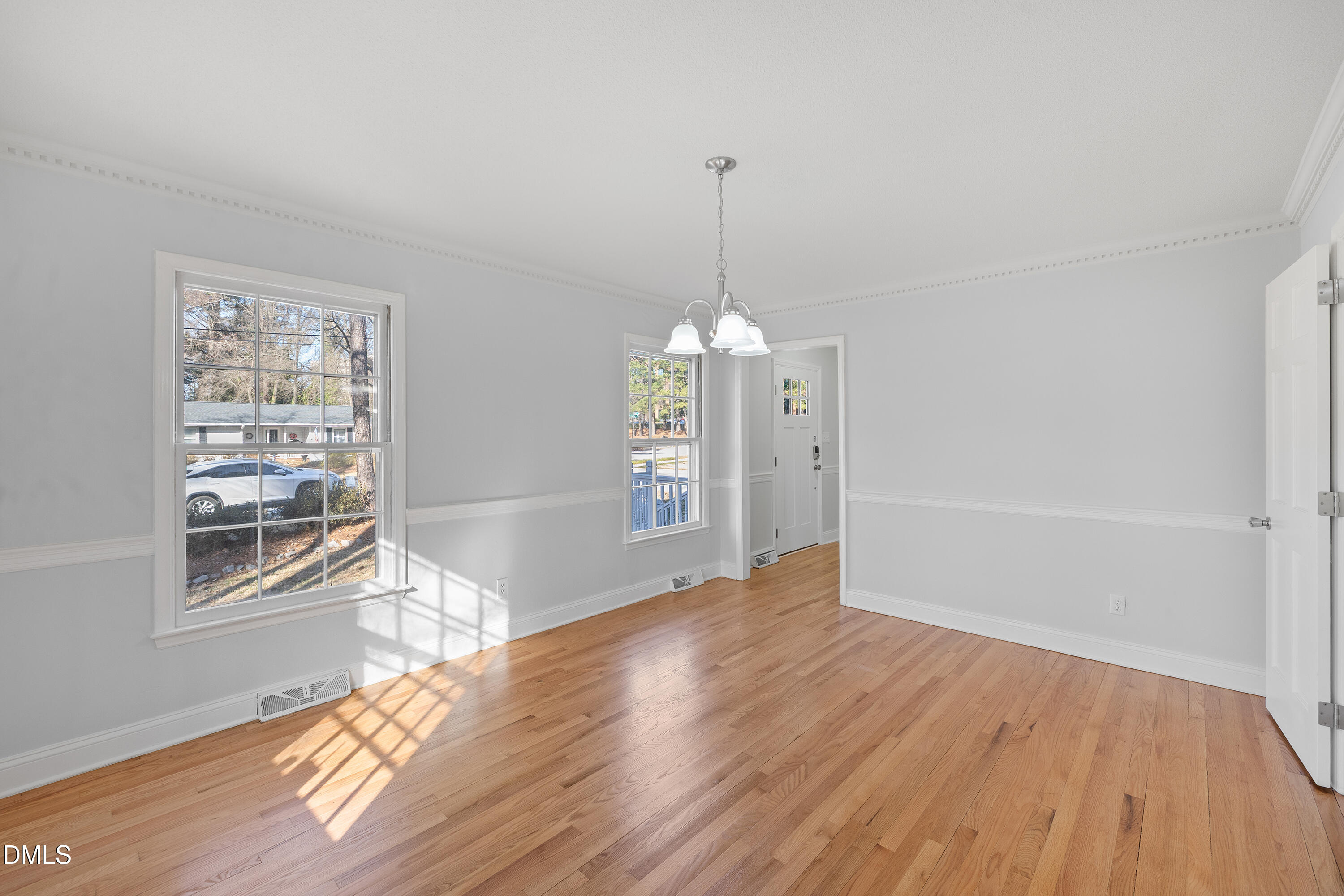 4601 Pemberton Drive Raleigh, NC 27609 - Photo 10 of 44 a view of empty room with wooden floor and window