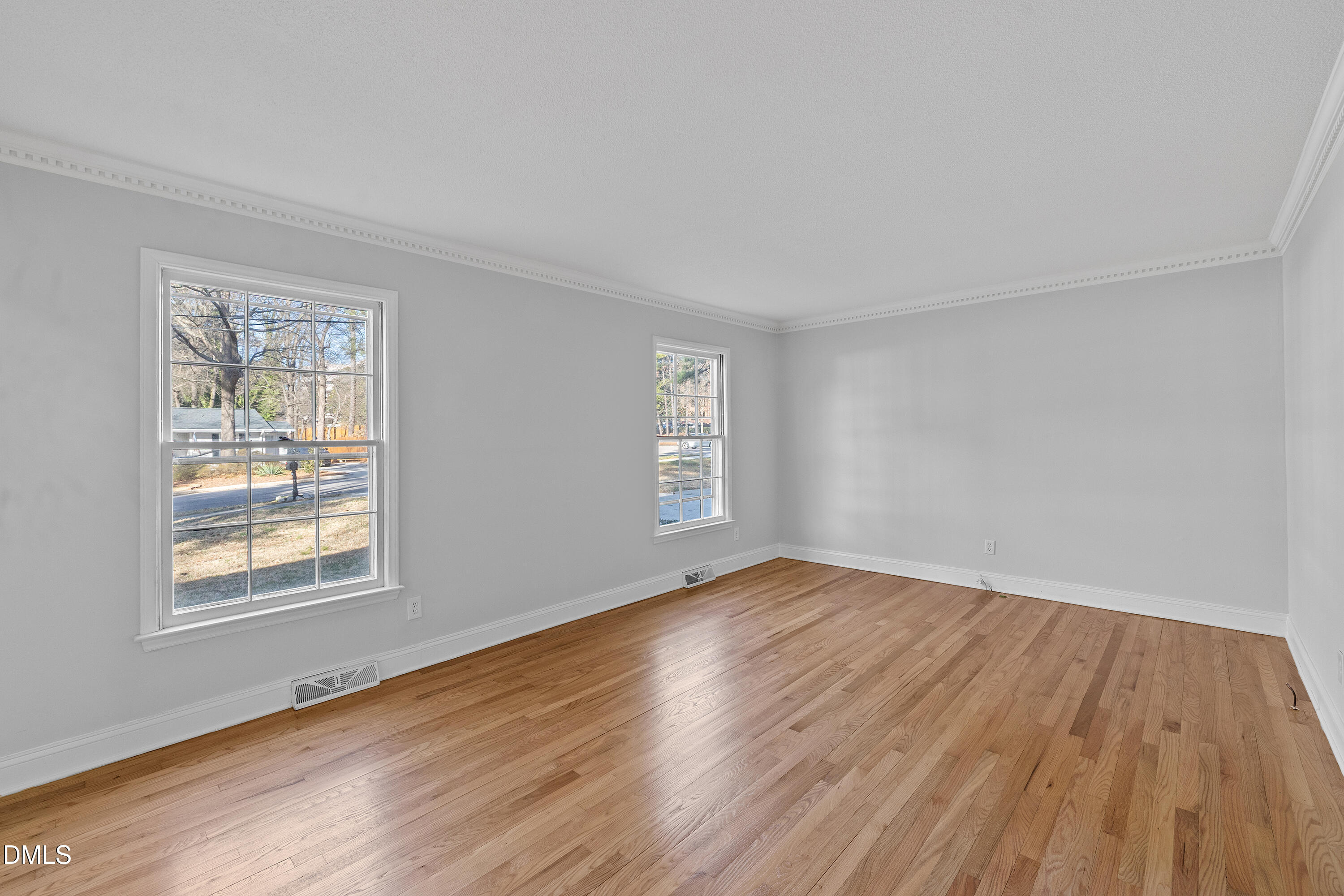 4601 Pemberton Drive Raleigh, NC 27609 - Photo 11 of 44 a view of an empty room with wooden floor and a window