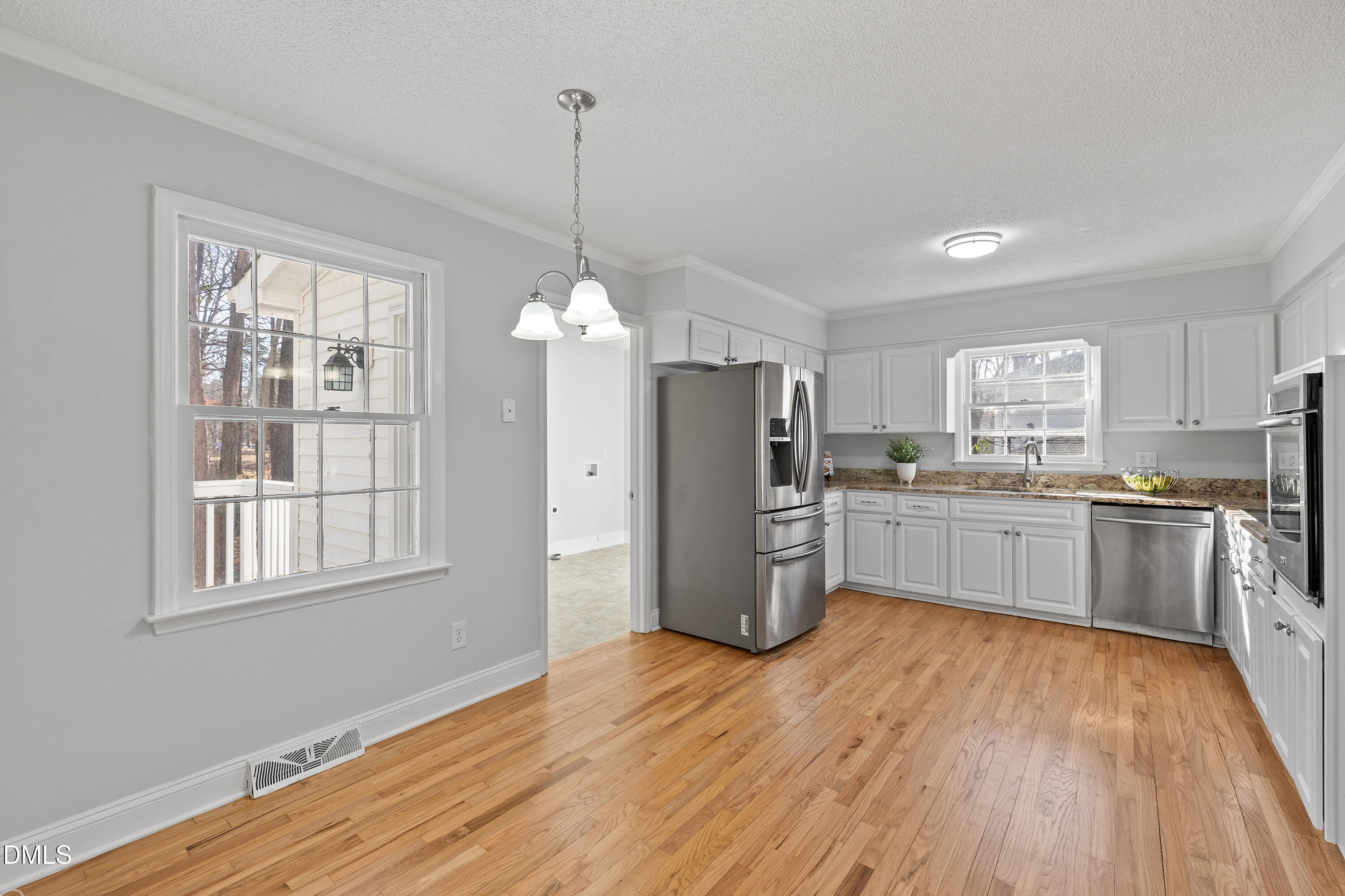 4601 Pemberton Drive Raleigh, NC 27609 - Photo 16 of 44 a kitchen with stainless steel appliances a refrigerator sink and cabinets