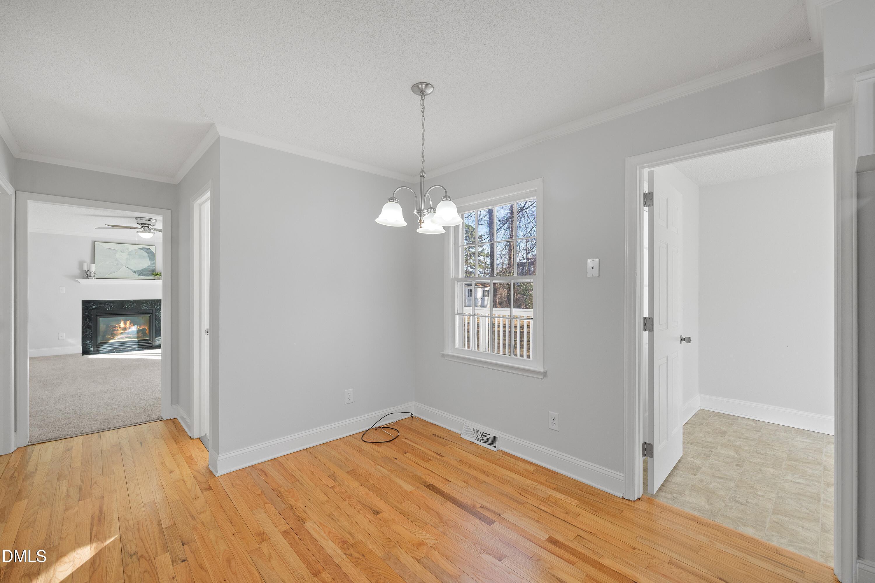 4601 Pemberton Drive Raleigh, NC 27609 - Photo 17 of 44 a view of an empty room with wooden floor and a window