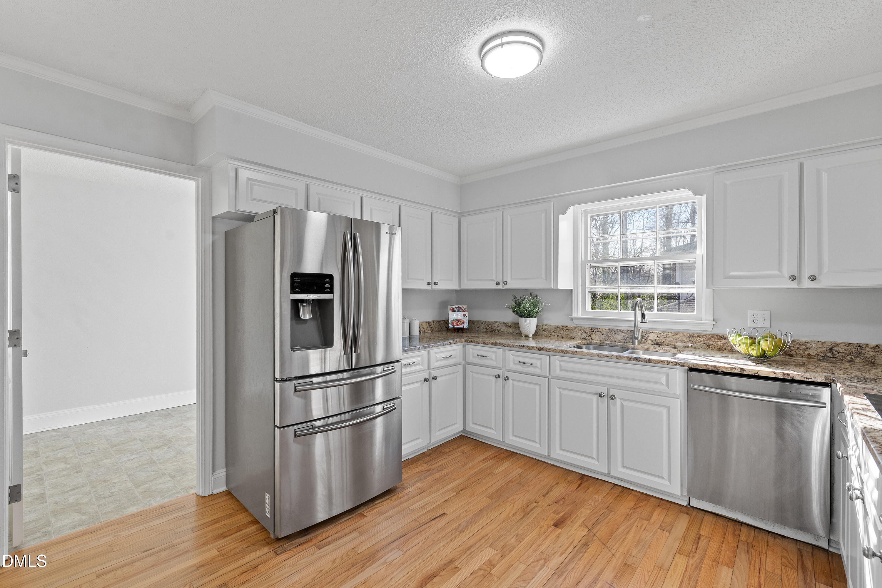 4601 Pemberton Drive Raleigh, NC 27609 - Photo 18 of 44 a kitchen with stainless steel appliances granite countertop a refrigerator a sink dishwasher a stove and white countertops with wooden floor
