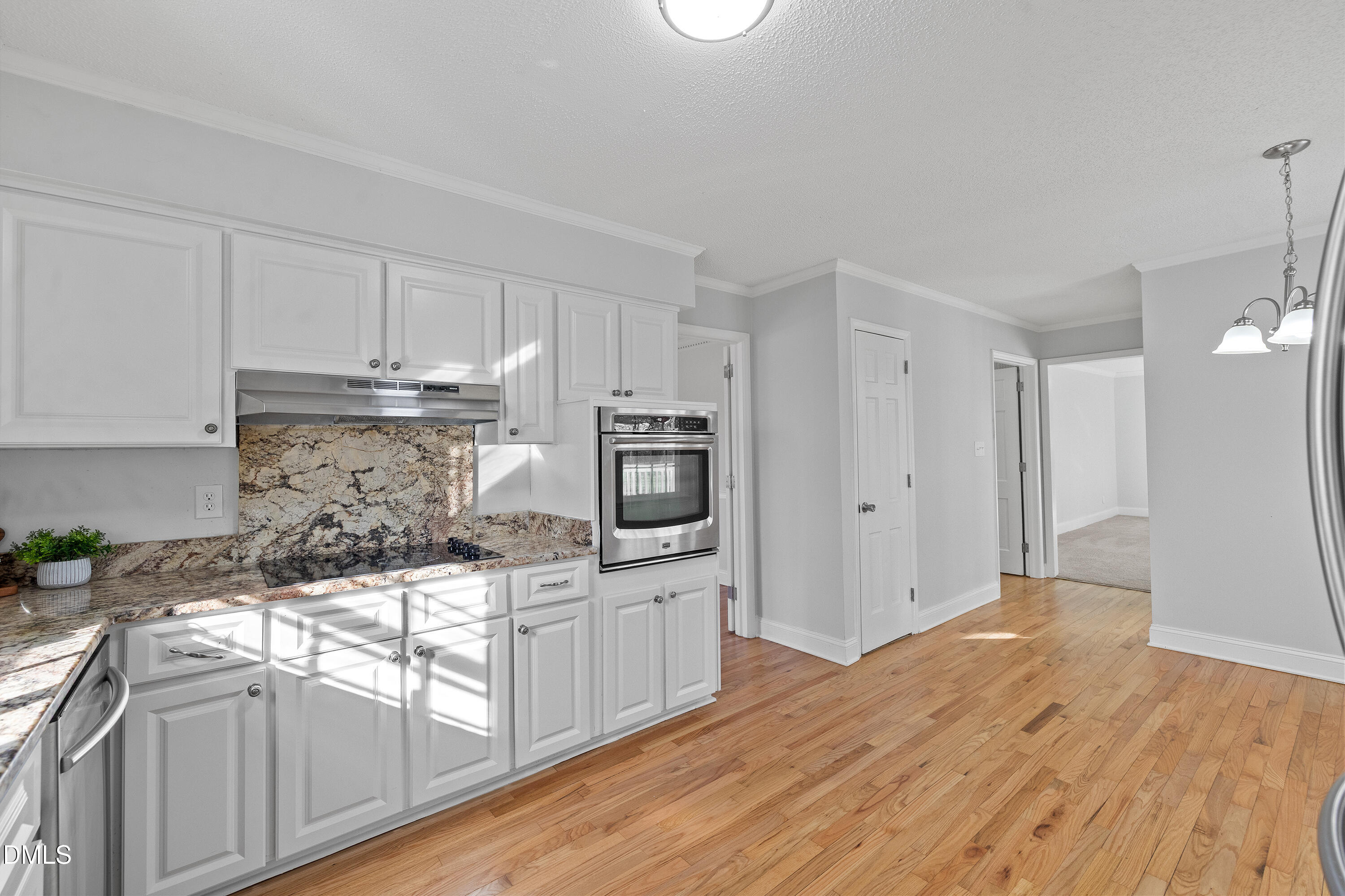 4601 Pemberton Drive Raleigh, NC 27609 - Photo 20 of 44 a kitchen with granite countertop a sink and cabinets