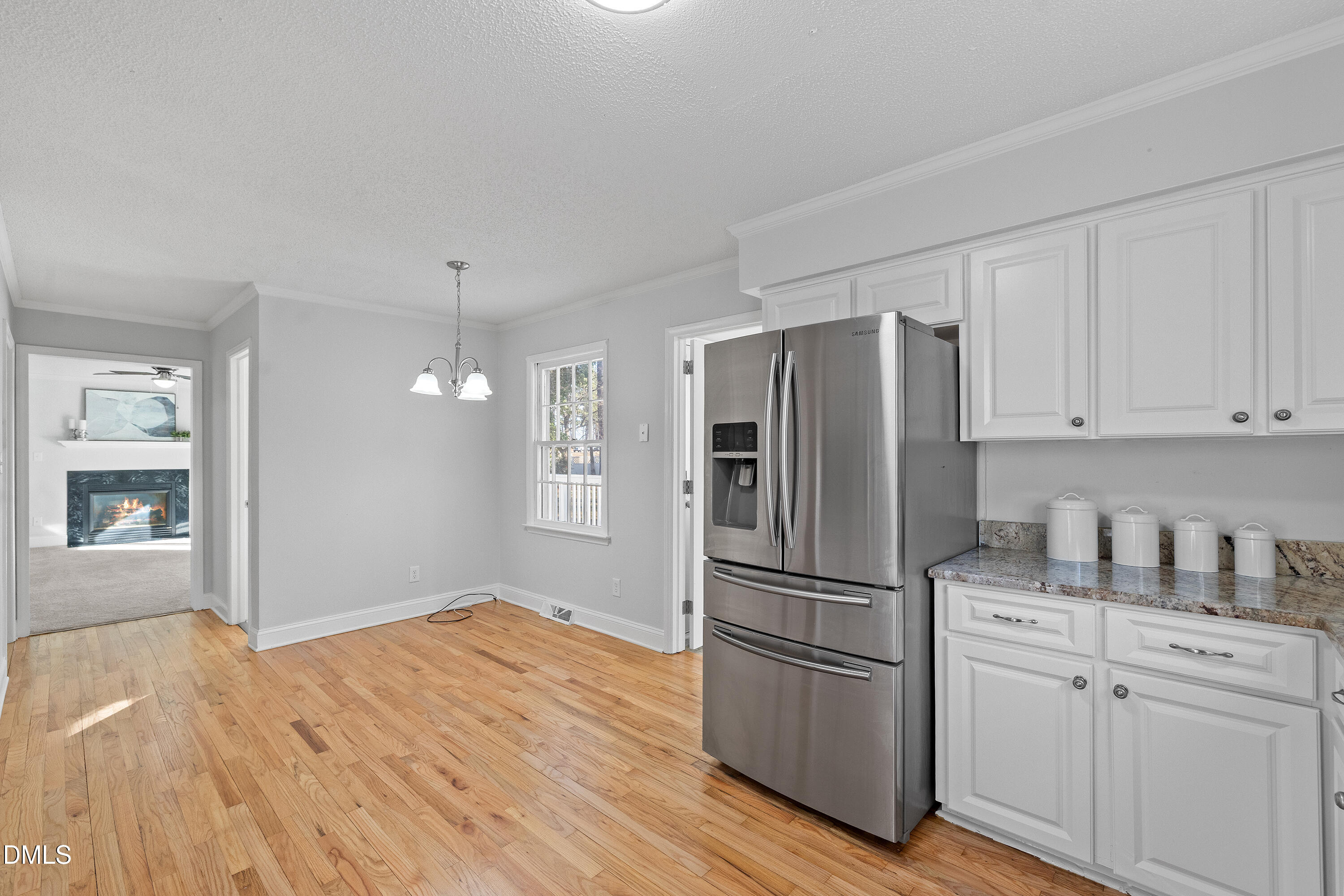 4601 Pemberton Drive Raleigh, NC 27609 - Photo 22 of 44 a kitchen with a refrigerator stainless steel appliances wooden floor and cabinets