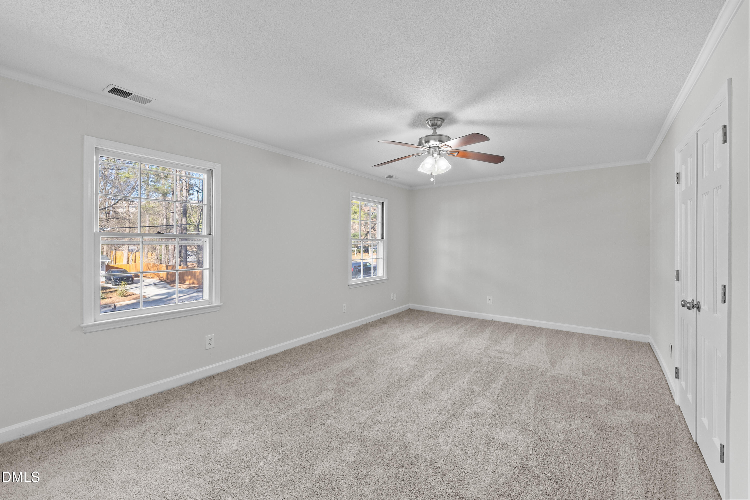 4601 Pemberton Drive Raleigh, NC 27609 - Photo 34 of 44 an empty room with windows and fan