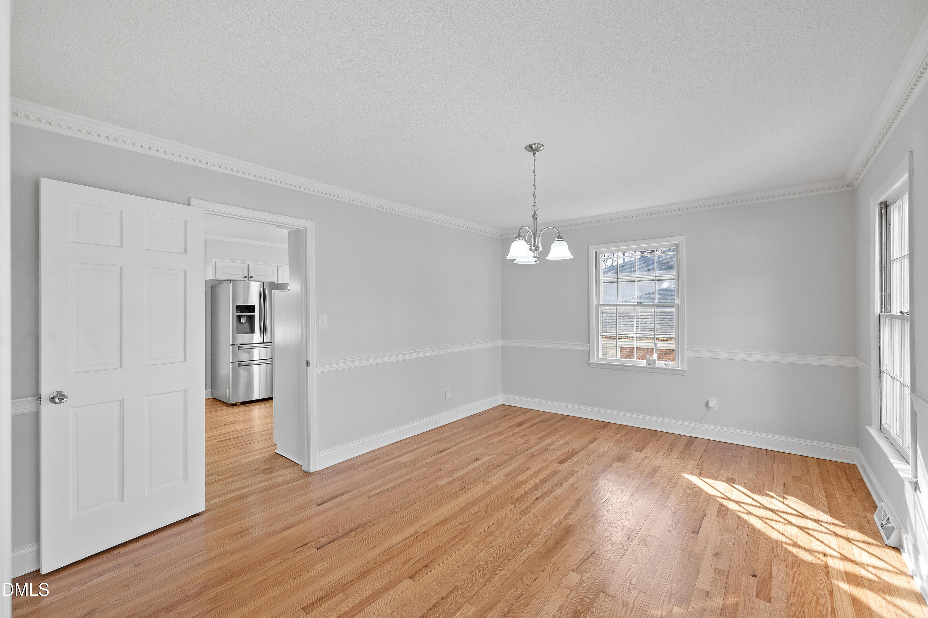 4601 Pemberton Drive Raleigh, NC 27609 - Photo 5 of 44 a view of empty room with wooden floor and window