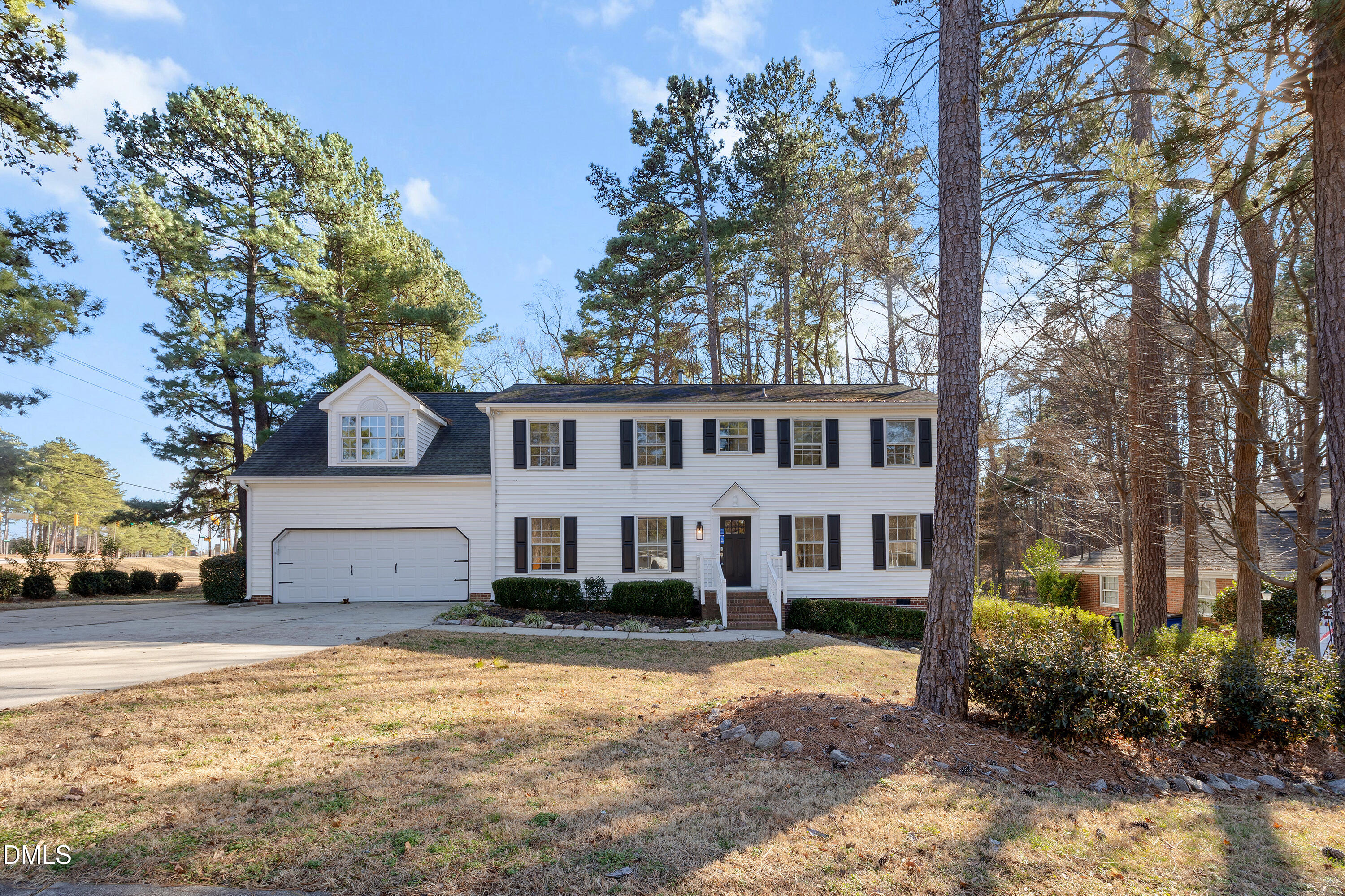 4601 Pemberton Drive Raleigh, NC 27609 - Photo 7 of 44 a view of a white house next to a yard with a large tree