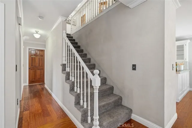 a view of entryway and gallery with wooden floor