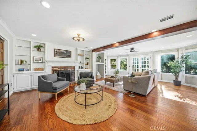 a living room with fireplace furniture and a large window
