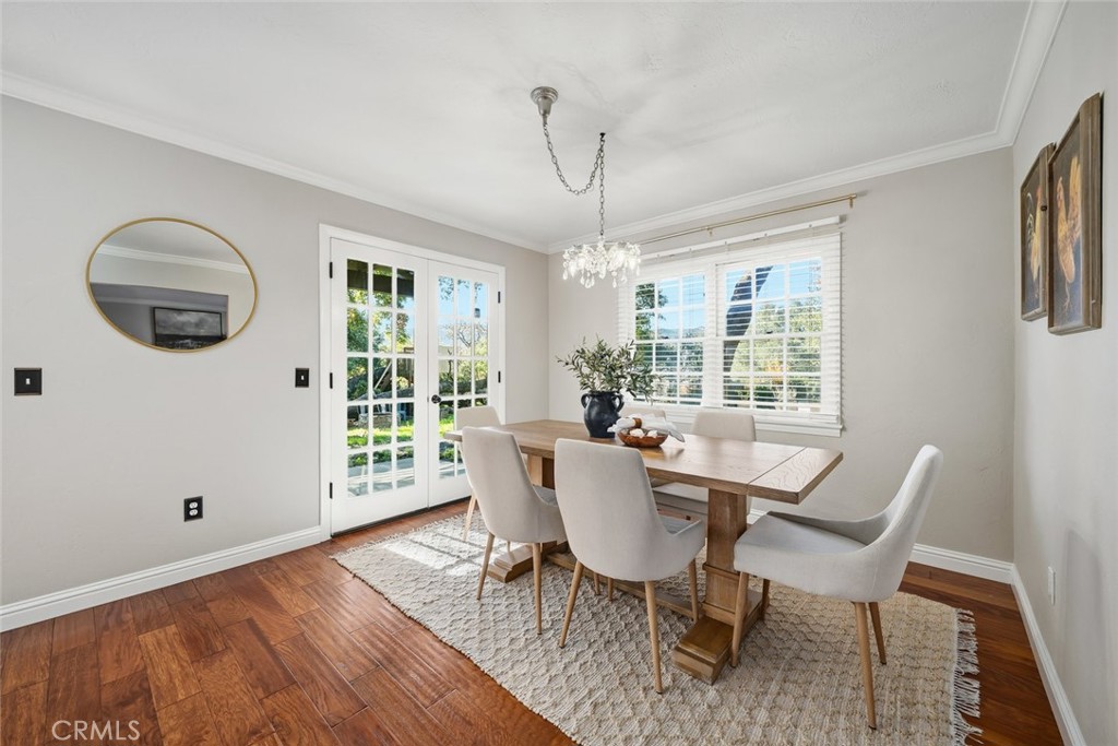 12250 San Antonio Road Atascadero, CA 93422 - Photo 25 of 46 a dining room with furniture a chandelier and wooden floor