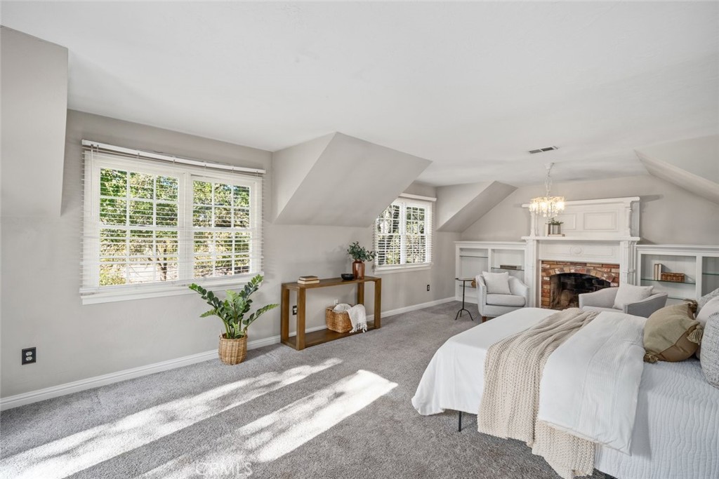 12250 San Antonio Road Atascadero, CA 93422 - Photo 27 of 46 a spacious bedroom with a bed a table and chair