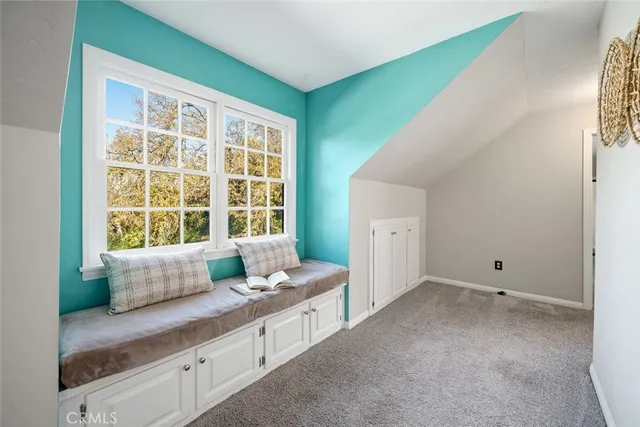 a bathroom with a granite countertop tub and a large window