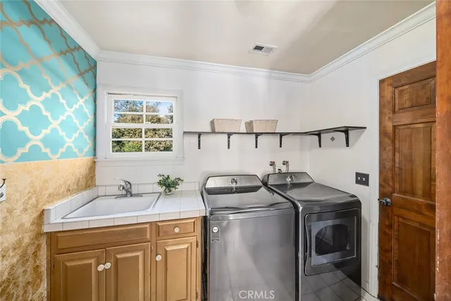 a utility room with closet dryer and washer