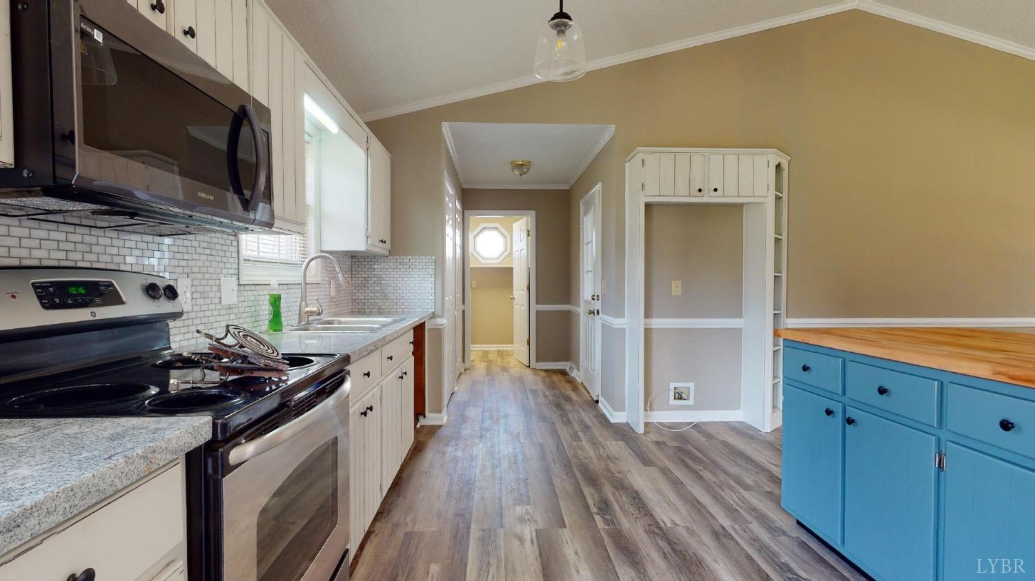 3328 Rocksprings Road Ringgold, VA 24586 - Photo 13 of 39 a kitchen with stainless steel appliances granite countertop a stove and a wooden floors