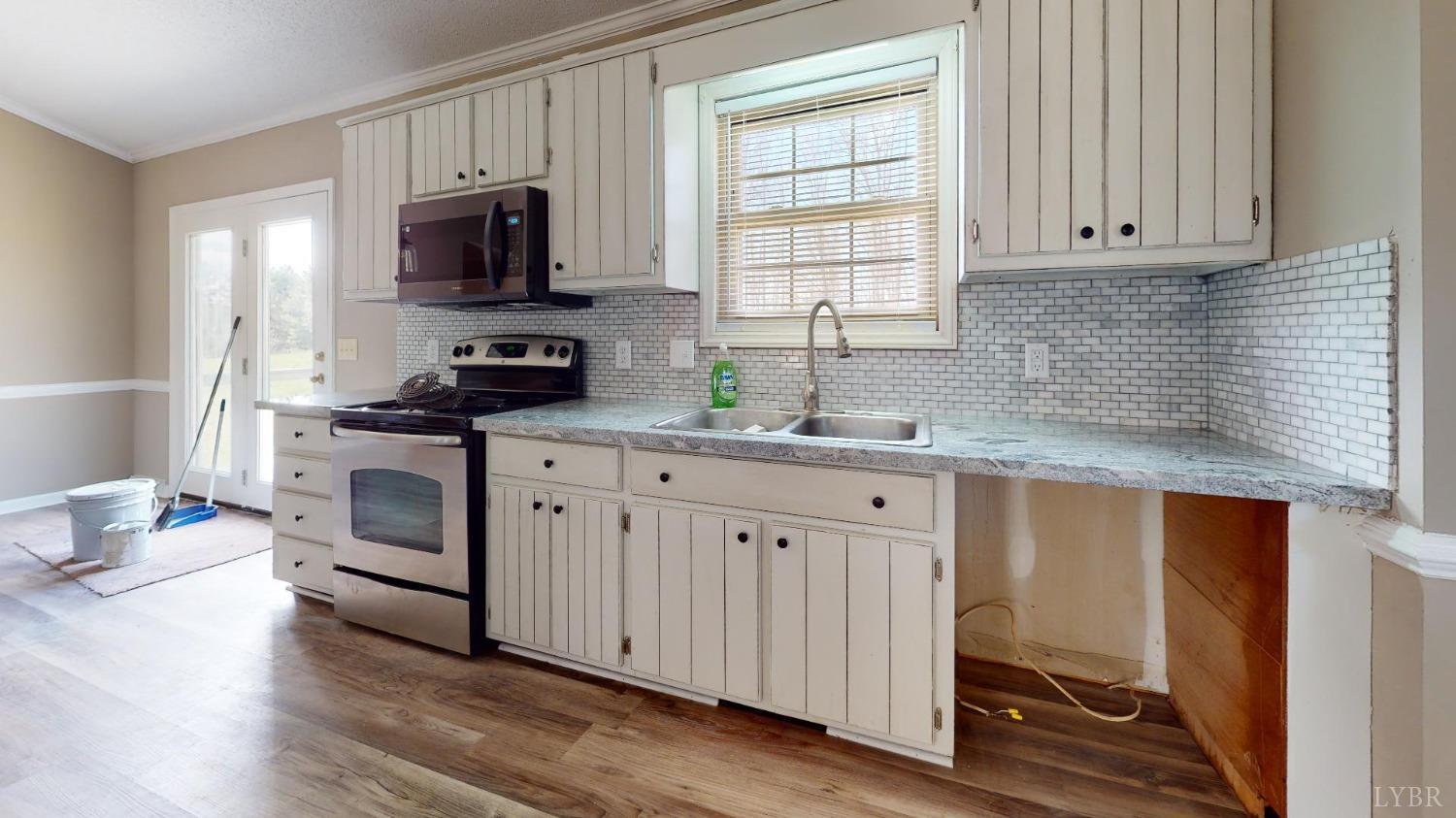 3328 Rocksprings Road Ringgold, VA 24586 - Photo 15 of 39 a kitchen with granite countertop white cabinets and white appliances