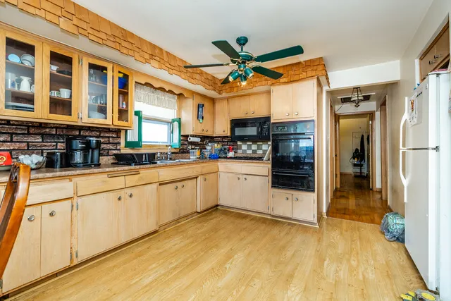 a kitchen with stainless steel appliances granite countertop a refrigerator and a stove top oven