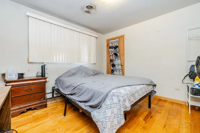 a bed sitting in a bedroom next to a window