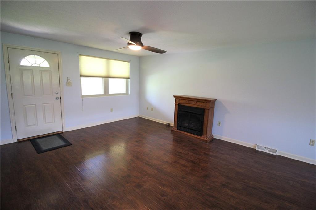 Te front door leads you  to the living room which is open to the dining room which gives you an open and flexible floor plan. Check out the hand carved hard wood floors...